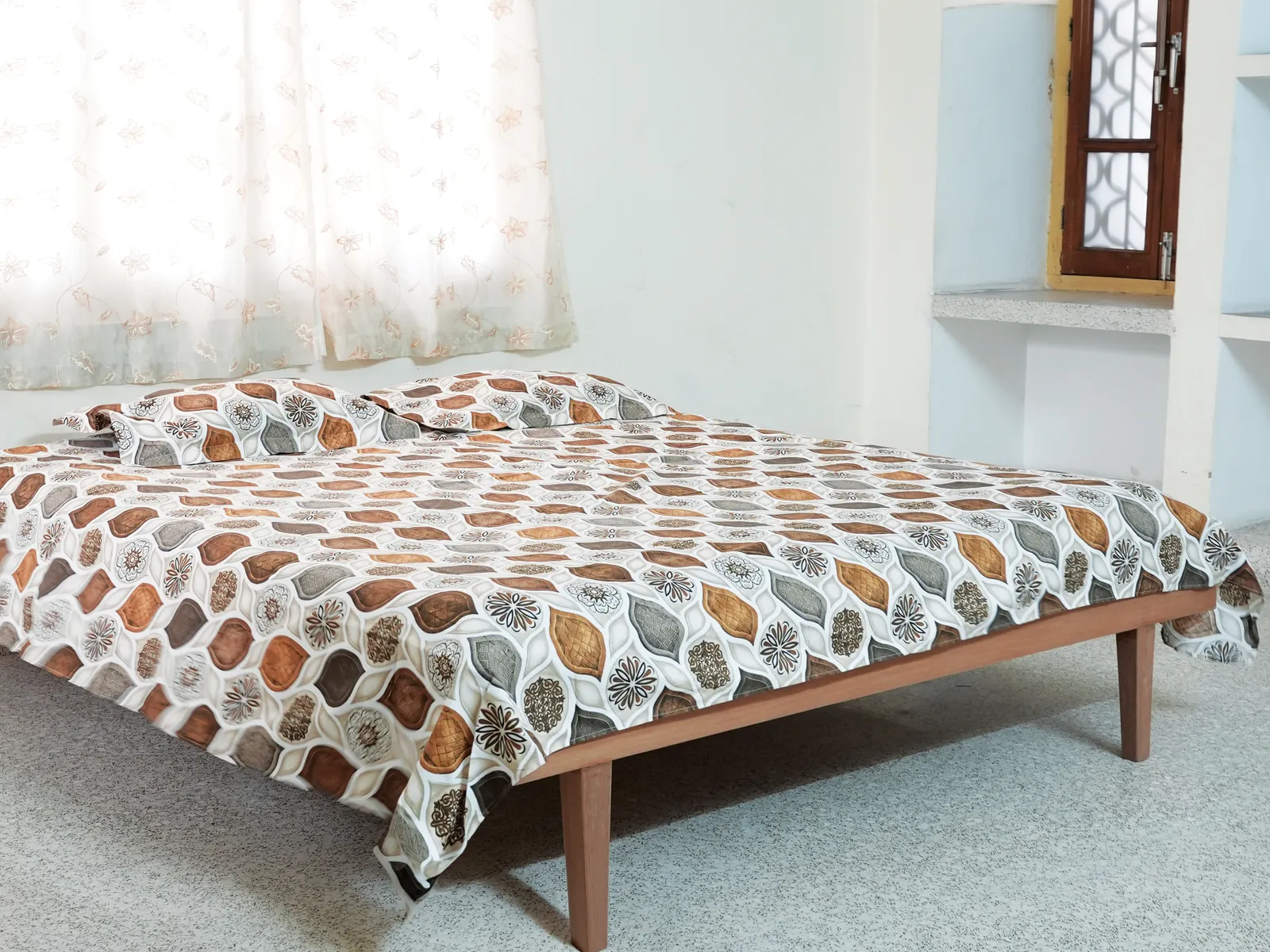 Bright, airy guest room with a double bed and soft curtains